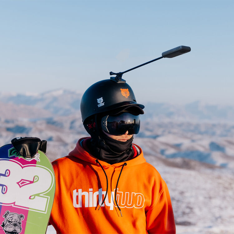 snowboarder wearing Insta360 Unicorn Helmet camera mount