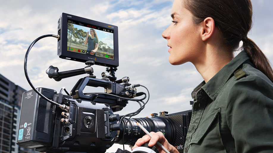 woman looking at video playback on her external camera screen