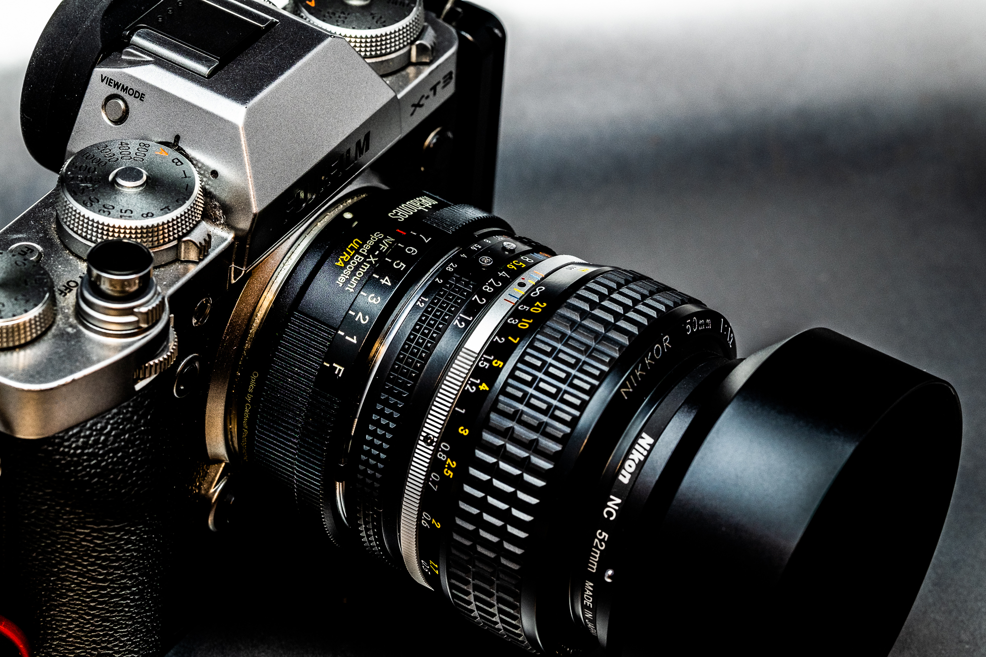 The Metabones Speed Booster is sandwiched between the FUJIFILM camera and Nikon 50mm lens.