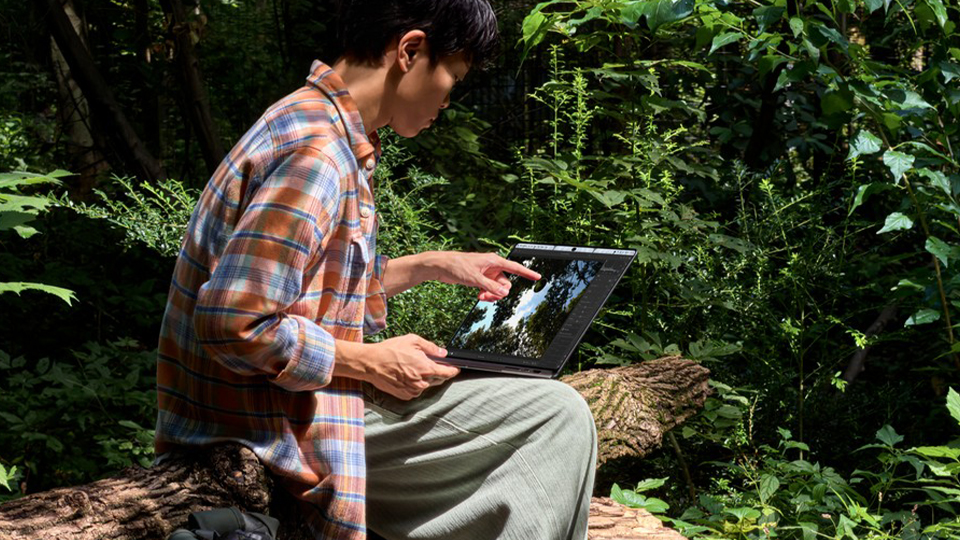 Young man outdoors with Apple 14 Inch MacBook Pro Young man outdoors with Apple 14 Inch MacBook Pro