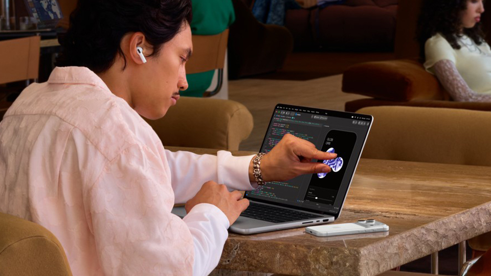 Young man with Apple 14 Inch MacBook Pro Young man with Apple 14 Inch MacBook Pro