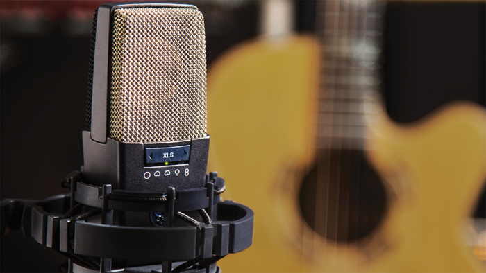 Condenser microphone in front of a guitar Condenser microphone in front of a guitar