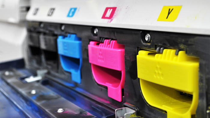 CMYK ink cartridges inside a photo printer