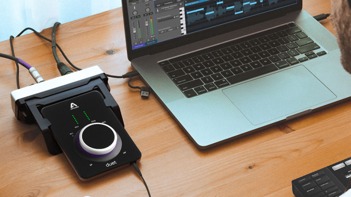 Apogee Electronics Duet 3 Ultracompact 2x4 USB-C Audio Interface in use on desk with laptop Apogee Electronics Duet 3 Ultracompact 2x4 USB-C Audio Interface in use on desk with laptop