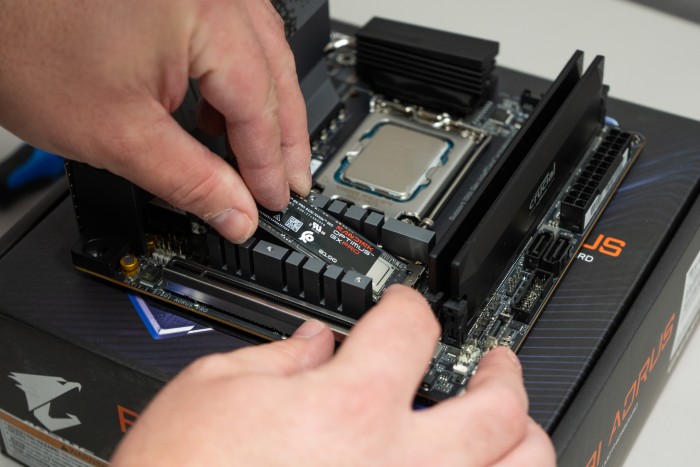 Installing the NVME SSD Drive into the M.2 Slot on the motherboard. Be sure to place the heatshield on the NVME M.2 SSD once installed Installing the NVME SSD Drive into the M.2 Slot on the motherboard. Be sure to place the heatshield on the NVME M.2 SSD once installed