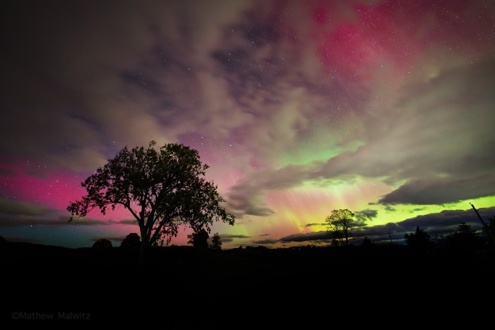 While not as vibrant, this lull in the aurora still delivers stunning colors and faint pillars seen on the right. The tree in the foreground anchors the scene and gives viewers a starting point that ties the scene together.