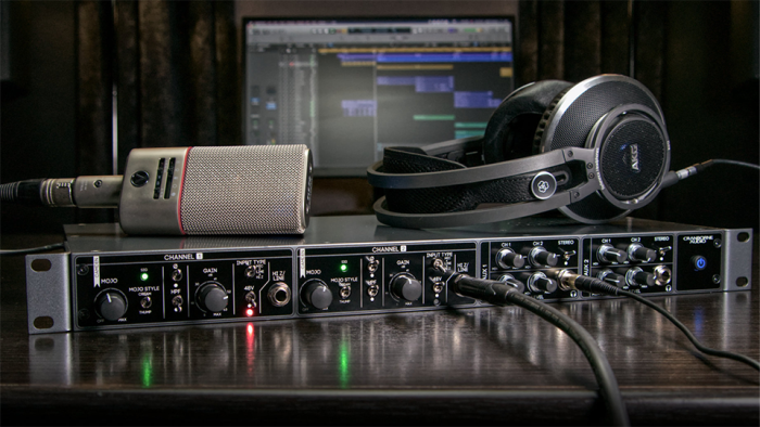 Preamp in use with microphone and headphones resting on top Preamp in use with microphone and headphones resting on top