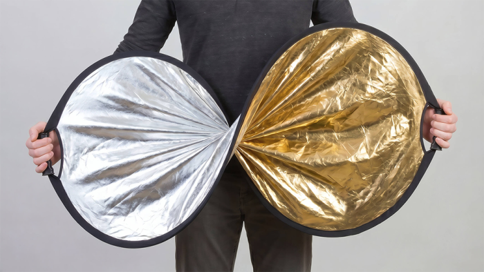 Person twisting reflector disc showing its flexibility