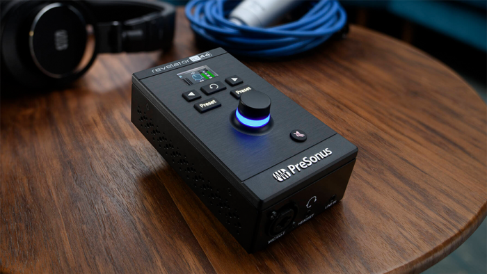 PreSonus Revelator io44 Ultracompact 4x2 USB Type-C Audio Interface in use on wooden table PreSonus Revelator io44 Ultracompact 4x2 USB Type-C Audio Interface in use on wooden table