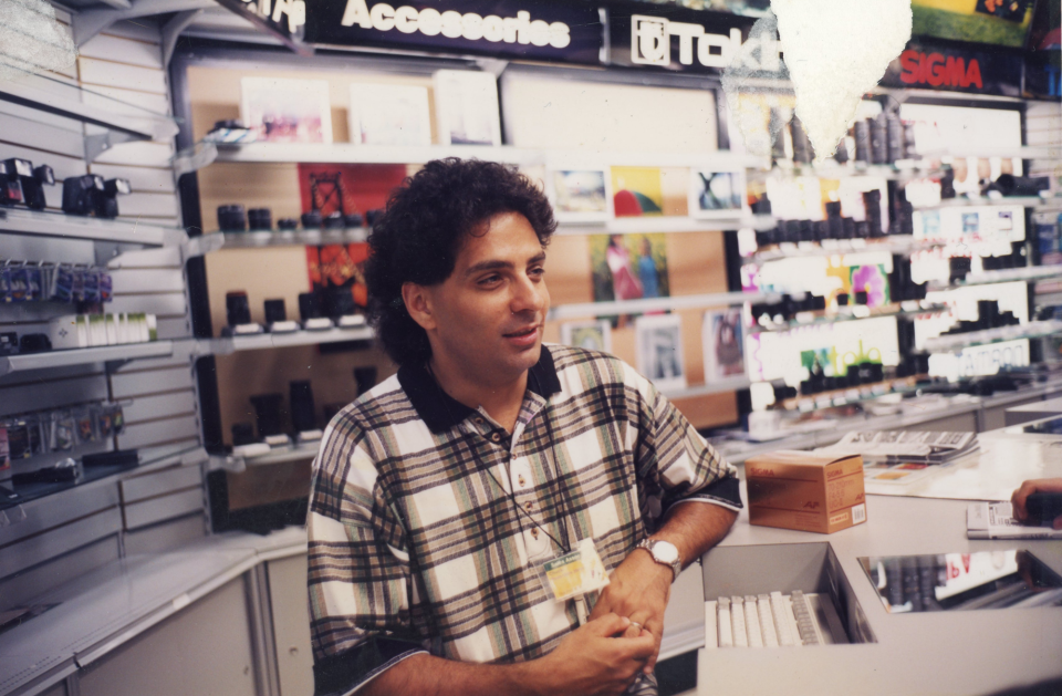 Chuck Capriola, behind the sales counter, soon after he was hired in the summer of 1998 at the 34th Street store.