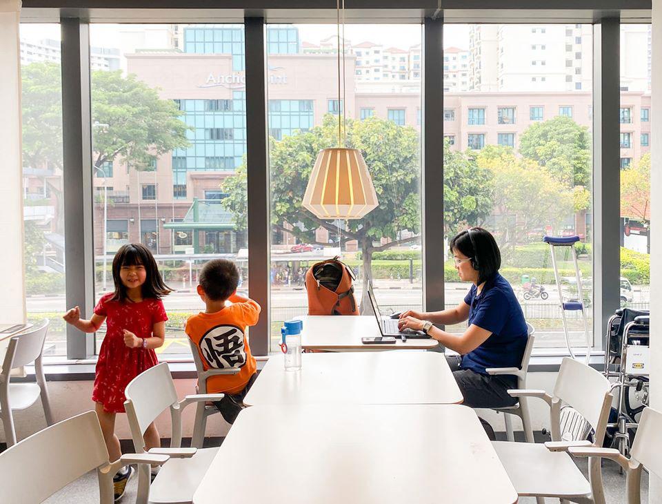 Working in Singapore without a fixed base meant that Chow and his family were everywhere. Pictured here, Chow’s wife concentrates on her laptop in an IKEA café with the children at her side.