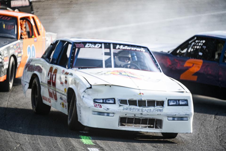 My shutter speed (1/1000th-sec) wasn’t fast enough to totally freeze the action during this near-miss spinout, but I did manage to hold focus on the lead car.