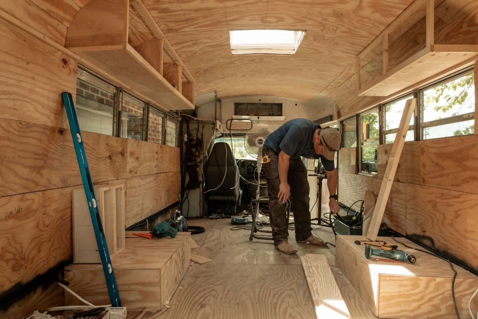 Leah's husband helping on the studio bus renovation.