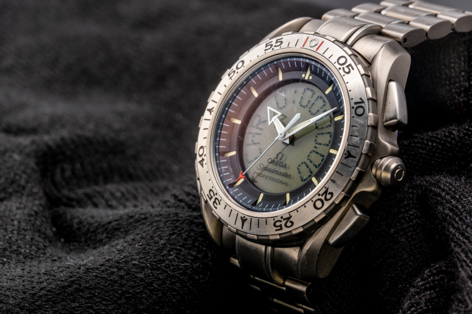 The Omega Speedmaster Professional X-33 Ref 3291.50.00 set to the time used by Omega when displaying this watch (it is discontinued). This image shows some of the wear and tear on the bezel and crystal after nearly 20 years of service.