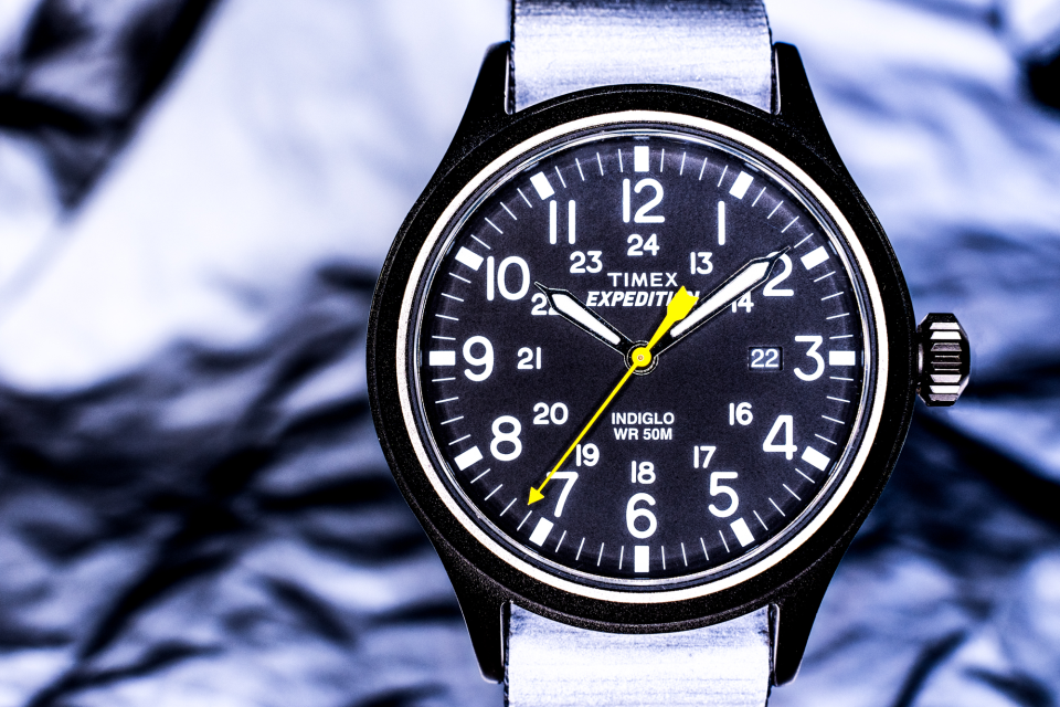 The Timex Expedition Scout 40mm Nylon watch with a reflective band and in front of reflective material. This shot was illuminated by a Bolt VM-160 LED Macro Ring Light.