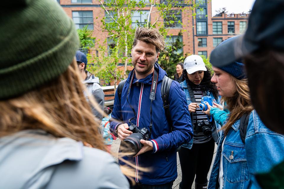 Scott Bakken, founder of Socality, leads a group over the High Line during the photo walk through NYC.