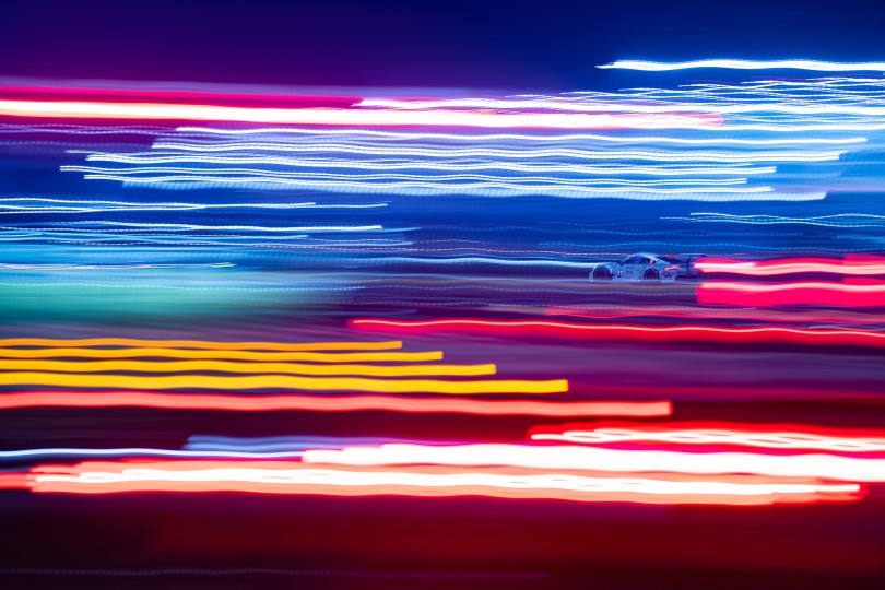 Porsche seen through the lights of emergency vehicles at the Daytona 24 hour race. Overnight hours offer a great opportunity to experiment with various lighting and long handheld exposure effects. Nikon D5, ISO 320, 70 mm f/5 lens at 1 second.