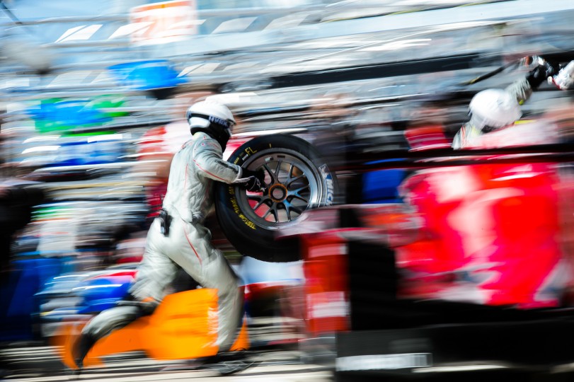 Pit crew member running with a tire during Le Mans 24-hour pit stop practice. Nikon D4, ISO 50, 190 mm f/22 lens at 1/13 second.