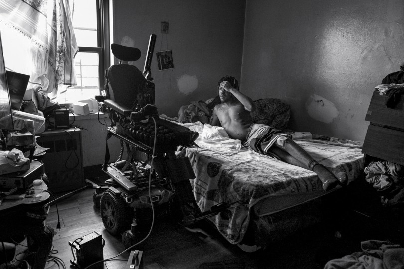 Malik and his wheelchair in his bedroom at the Mitchel Houses.