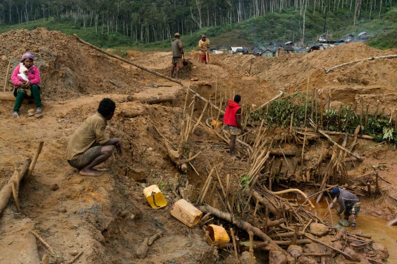 Men shovel and pump water at the Bemainty sapphire mining site, inside of the Ankeniheny - Zahamena Corridor (CAZ), a protected area in Madagascar. Beginning in 2015, when the sapphire rush was first underway, this section quickly became a threat to the rain forest’s flora and fauna, July 29, 2018. © Adriane Ohanesian
