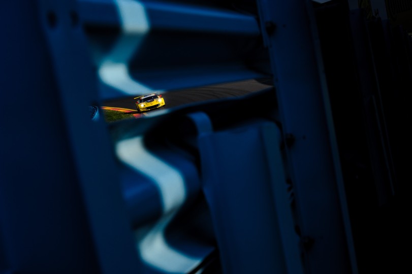 Early morning light accentuates the guard rail and frames a Corvette C7.R during a short warm up session for the 2018 Watkins Glen 6-hour race. Nikon D3, ISO 200, 80 mm f/8 lens at 1/1000.