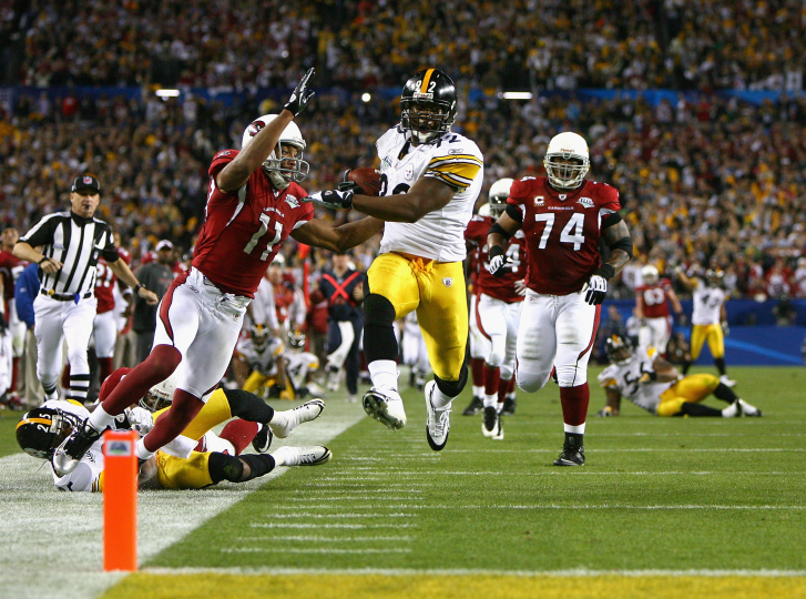 James Harrison of the Pittsburgh Steelers scores a touchdown against the Arizona Cardinals during Super Bowl XLIII. Photograph © Al Bello/Getty Images