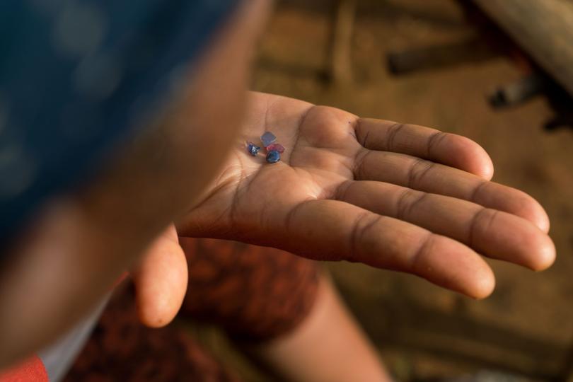 Laurence Asma, age 41, shows off sapphires that she, her husband, and team of about twenty workers found in the largest mining site in Bemainty, inside of the Ankeniheny - Zahamena Corridor (CAZ), a protected area in Madagascar, July 28, 2018. © Adriane Ohanesian