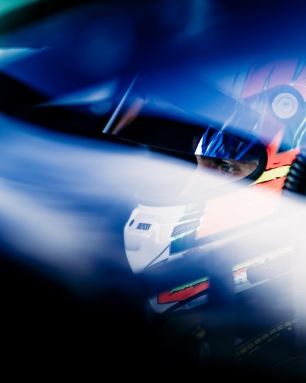 Harsh reflections from shooting through Lexan windows are often frustrating, but careful use of light & shadow can offer ways to frame specific elements, such as the concentrated gaze of driver Seb Priaulux before a qualifying session. Nikon Z9, ISO 125, 135 mm f/1.8 lens at 1/1250.