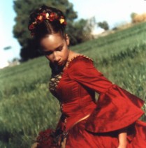 Enrique’s sister, Rosa poses in her Quinceañera dress for a portrait.