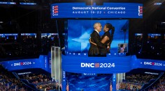 Barack and Michelle Obama embrace on stage during the Democratic National Convention, Chicago, IL, August 2024.
