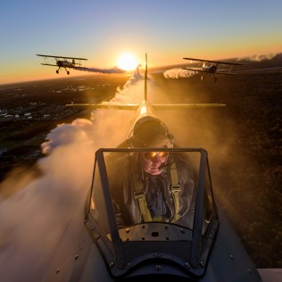“CAMERAS IN THE SKY” Aerial view of three open cockpit planes, shot from the cockpit, Florida.