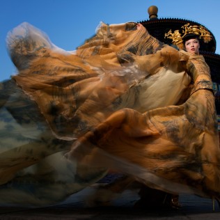“GOWN IN THE WIND” Wearing a gown styled by a top Beijing fashion designer, the model poses in front of the Temple of Heaven.