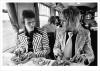 David Bowie and Mick Ronson on train to Aberdeen, 1973 © Mick Rock