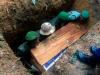 Okapi Wildlife Reserve park rangers help to lower the body of their young porter, Lokana Tingiti, into the ground during the funeral of the rangers outside of the town of Epulu, in the Democratic Republic of Congo, July 17, 2017. © Adriane Ohanesian