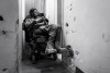 Malik maneuvres his wheelchair in the narrow hallway of his apartment.