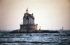 Original Source: Weitz used a sunset photograph of a lighthouse as source for more than a dozen interpretations featuring cameras floating on water or riding waves. © Allan Weitz